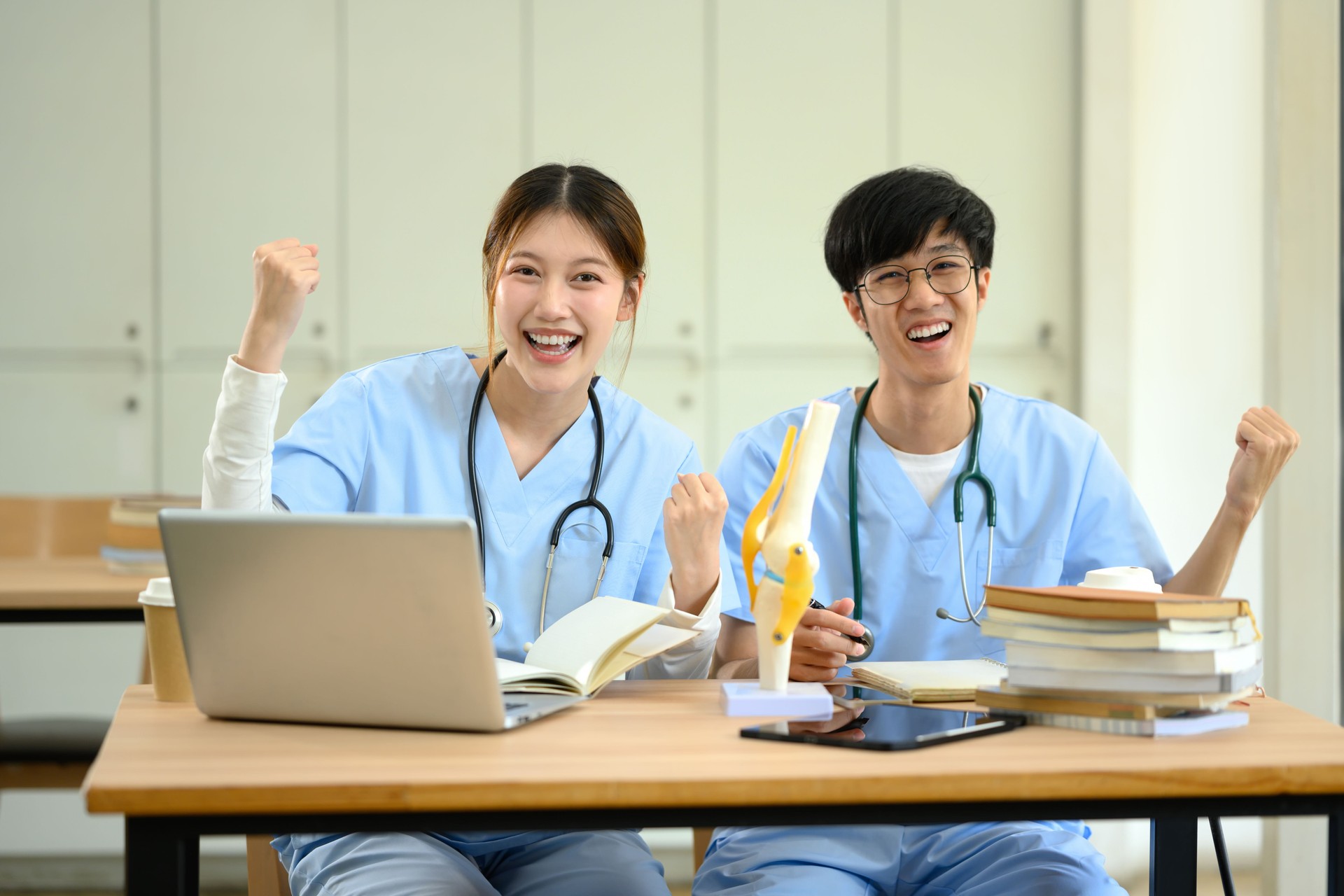 Excited medical students celebrating success in study